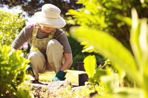 Gardener clearing waste in a small Willesden terrace garden