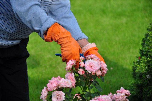 Worker wearing protective gear using landscaping tools safely